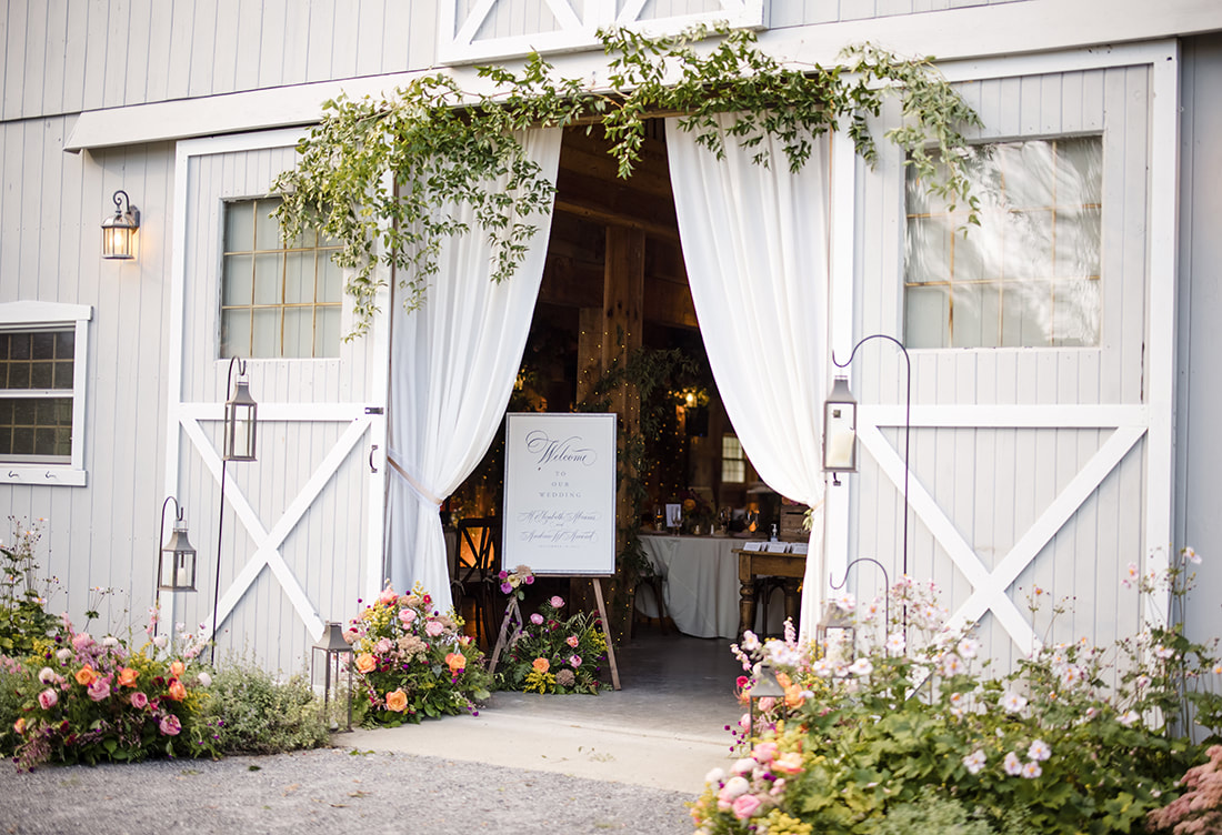 Barn entrance, wedding reception, florals, candle lighting 