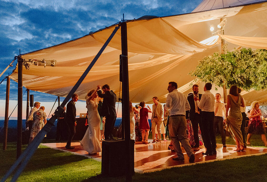 Tent entrance, wedding reception, dancing, floral centerpiece