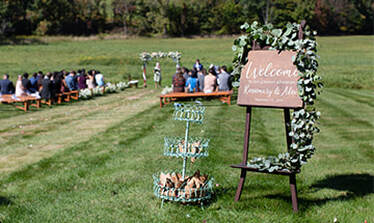 Signage, favors, wedding ceremony, outdoor wedding, floral arrangement