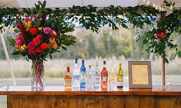bar, wedding reception, flower arrangement, signage, tent