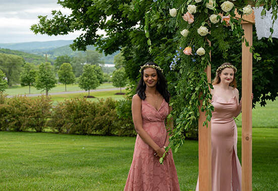 outdoor wedding ceremony, bridal party, floral arrangements
