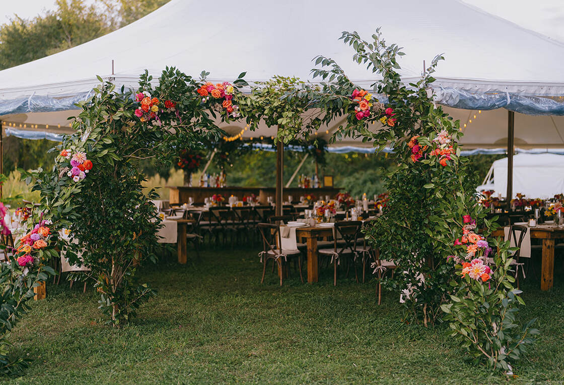Wedding tent entrance, flower arrangement, seating, reception